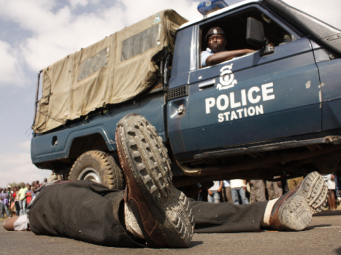 kenyan police car next to a corps