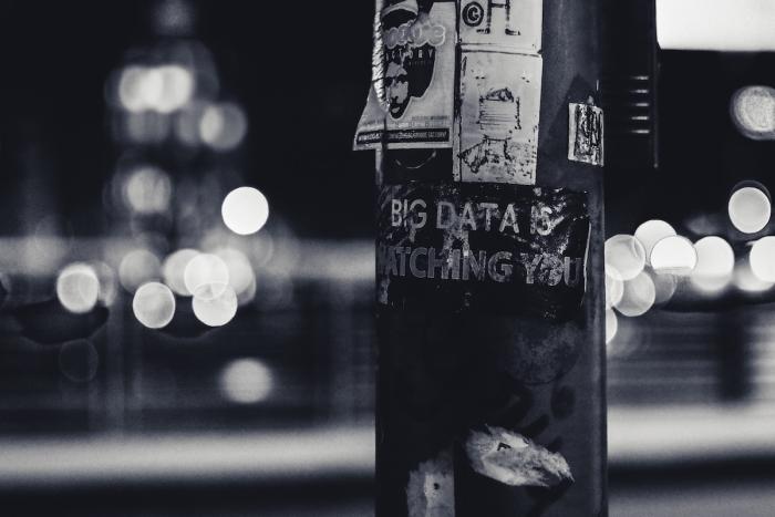 Image of signpost with poster 'big data is watching you'