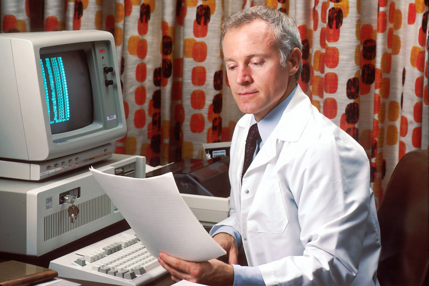 Old school male doctor on computer