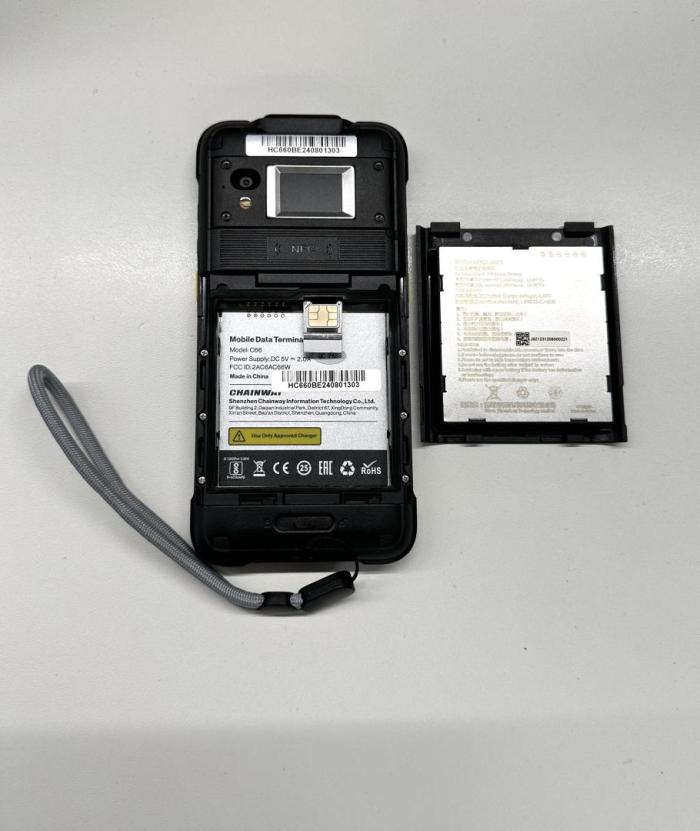 Photo of the back of the test device with the battery component opened and SIM card pocket pulled out,