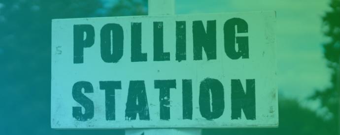 A black and white sign showing the words Polling Station and a left pointing arrow