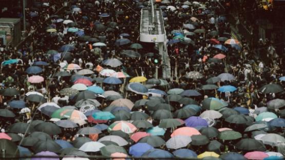 Crowds using umbrellas