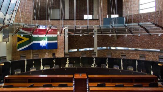 A courtroom and a flag of South Africa