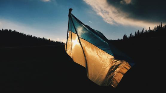Ukrainian flag on mountain backdrop