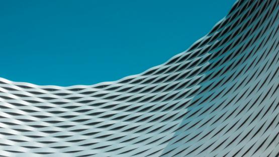 A building with wavy lines on it against a blue sky