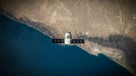 A satellite hovering above the coastline. 