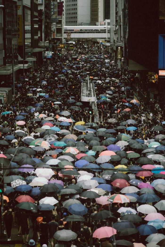 Crowds using umbrellas