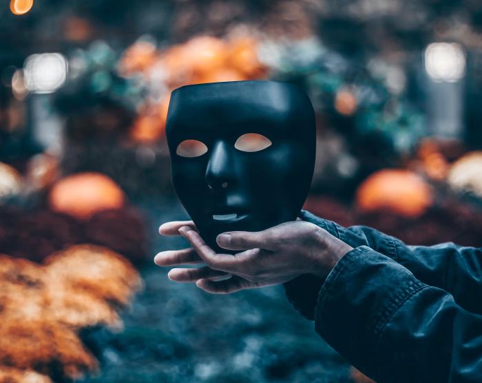 Hands holding mask