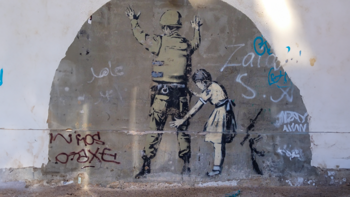 Banksy graphity in West Bank (Palestine) - girl searching a soldier