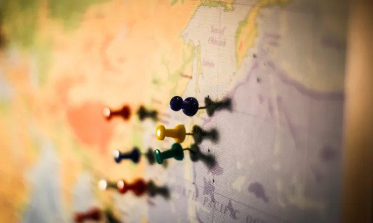 Map with pins on a board