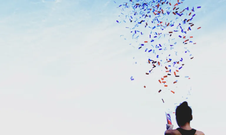 Person setting off confetti in celebration
