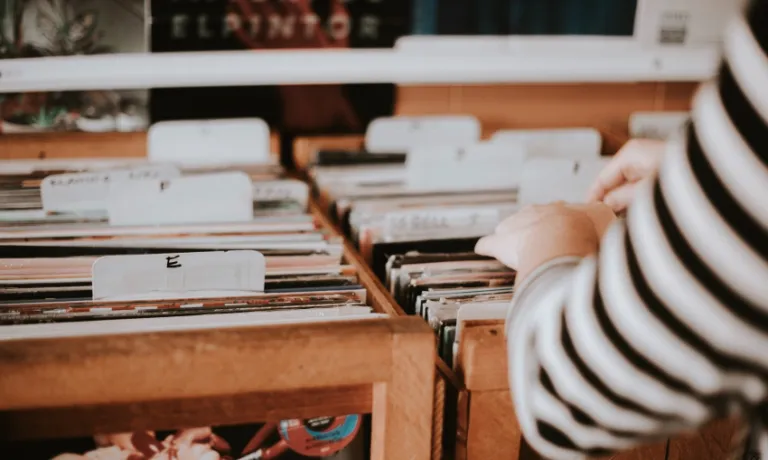 Hand going through a collection of vinyl music records