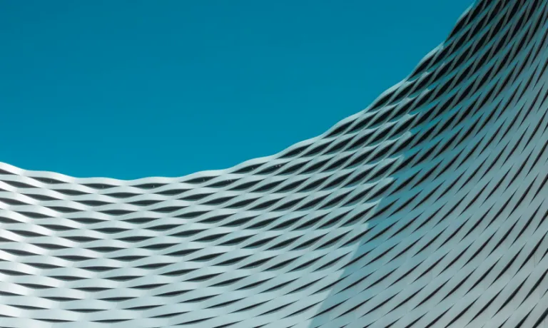 A building with wavy lines on it against a blue sky