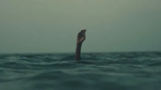 Hand in sea drowning