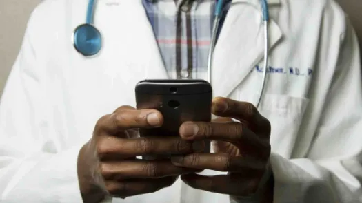 Image of doctor holding phone