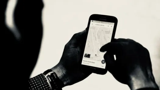 person holding phone looking at map