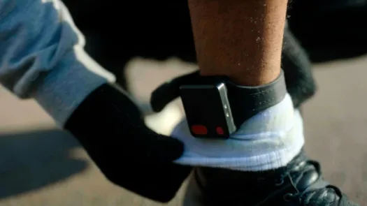Photo of a GPS ankle tag on someone's leg