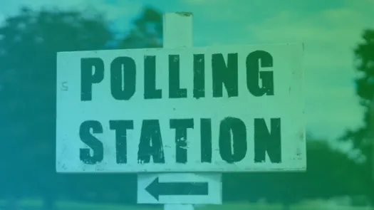 A black and white sign showing the words Polling Station and a left pointing arrow