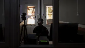 Man in the dark looking at laptop 