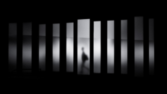 Man walking behind bars