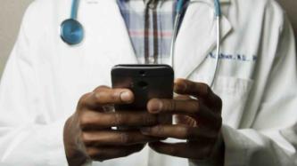 Image of doctor holding phone