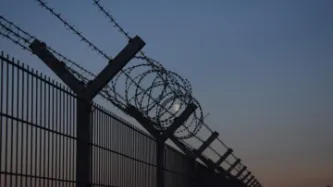 Barbed wire fence at sunrise