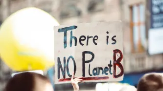 A protester holding a placard "There is no planet B"