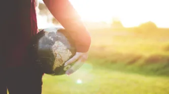 A person holding a globe