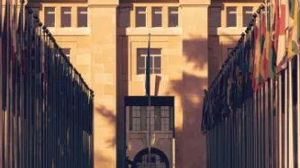 Photo of UN Geneva headquarters with flags.